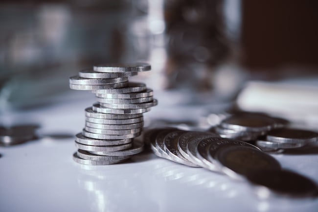 bottles-of-cash-with-coins-in-saving-money-concept-scaled