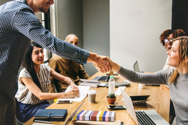 business-people-shaking-hands-in-agreement-scaled-1