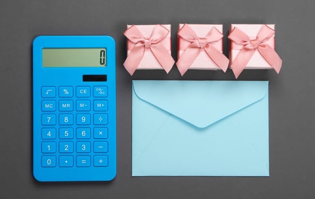 calculator-with-envelope-and-gift-box-on-gray-scaled