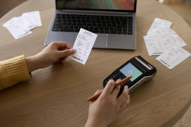 close-up-hand-holding-receipt-scaled