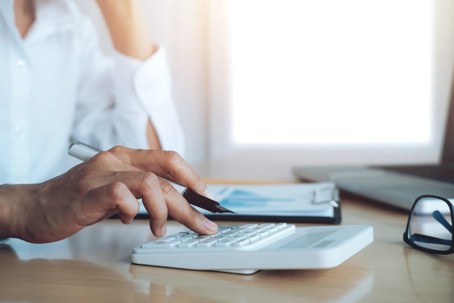 finances-saveing-economy-concept-female-accountant-or-banker-use-calculator-scaled