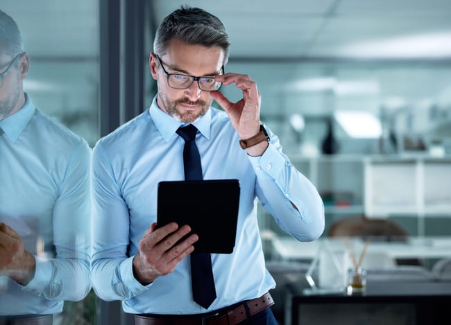 great-things-happen-when-you-use-right-tools-shot-businessman-using-digital-tablet-office-scaled