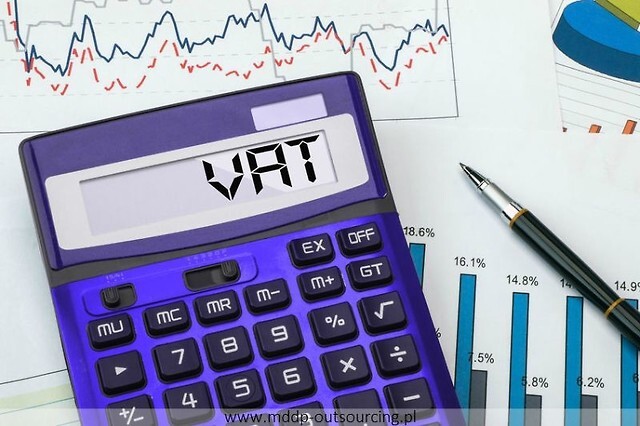 kalkulator z napisem VAT na monitorze na tle wykresów