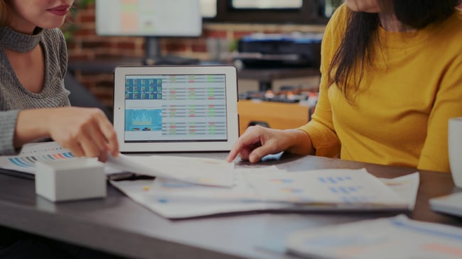 coworkers-looking-stock-market-statistics-tablet-developing-business-project-women-analyzing-sal