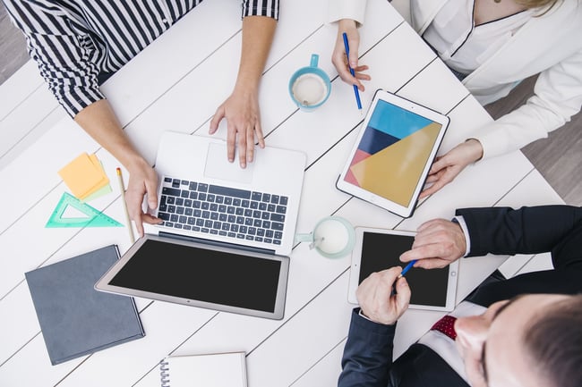 crop-coworkers-using-modern-devices-at-desk-scaled
