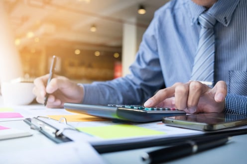 business-finance-man-calculating-budget-numbers-invoices-and-financial-adviser-working-scaled