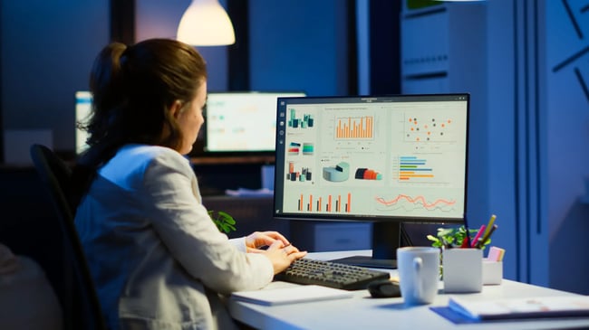 busy-woman-working-at-night-in-front-of-computer-scaled