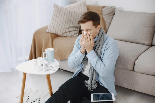 sick-guy-in-living-room-middle-age-man-feeling-sick-with-cold-and-fever-at-home-man-in-a-medical-mask-scaled