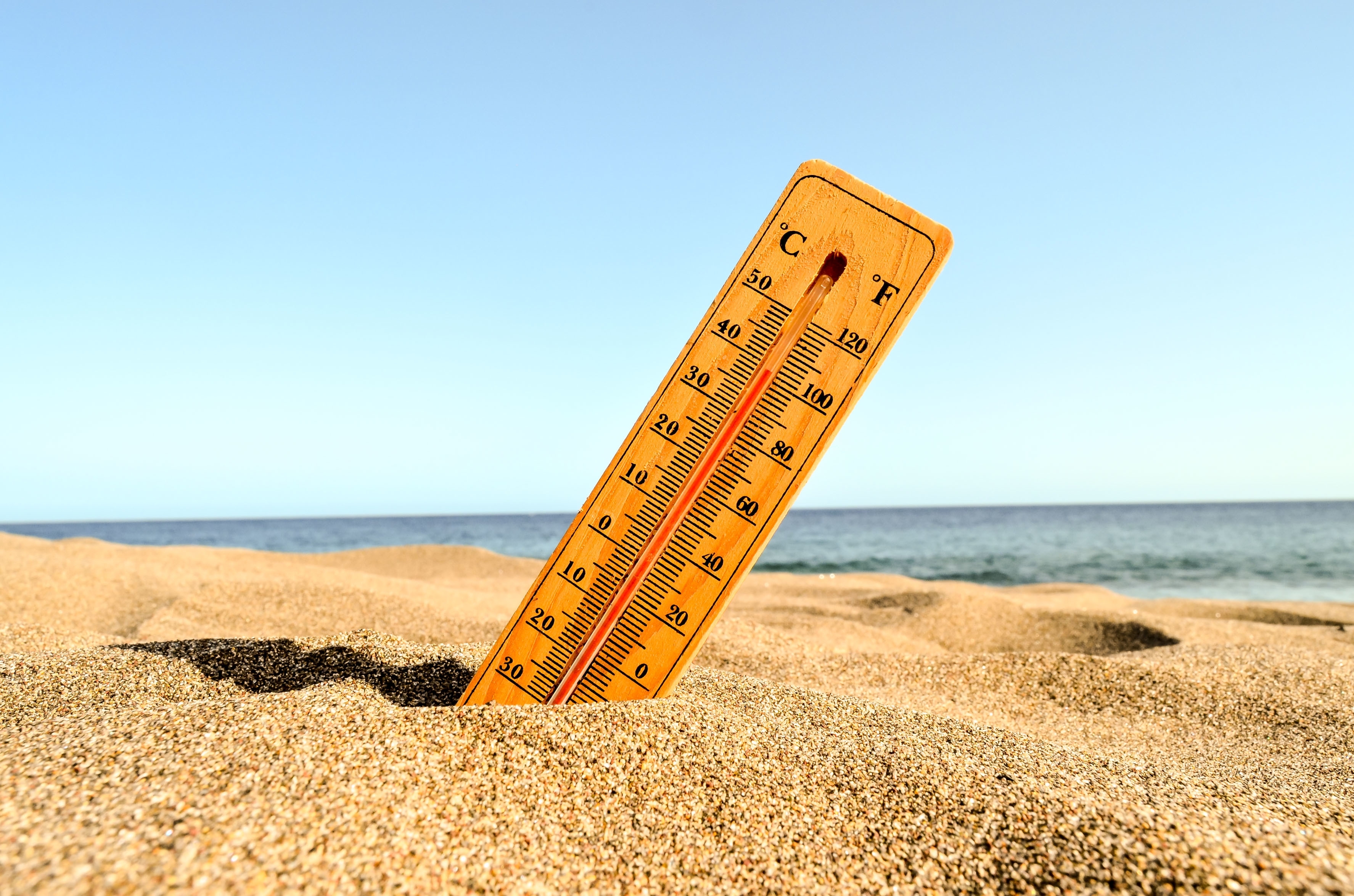 closeup-shot-thermometer-beach-sand