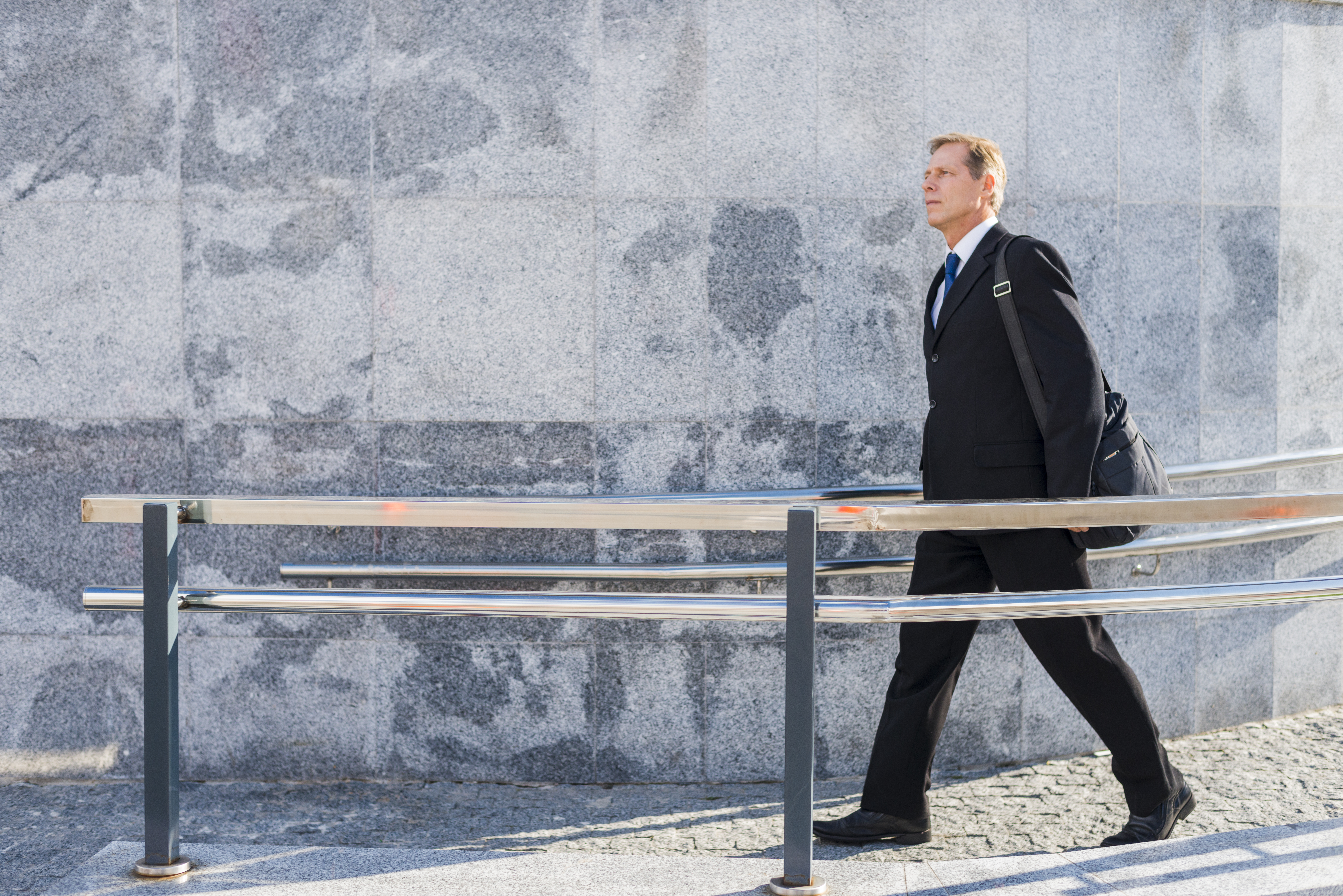 side-view-mature-man-walking-near-railing