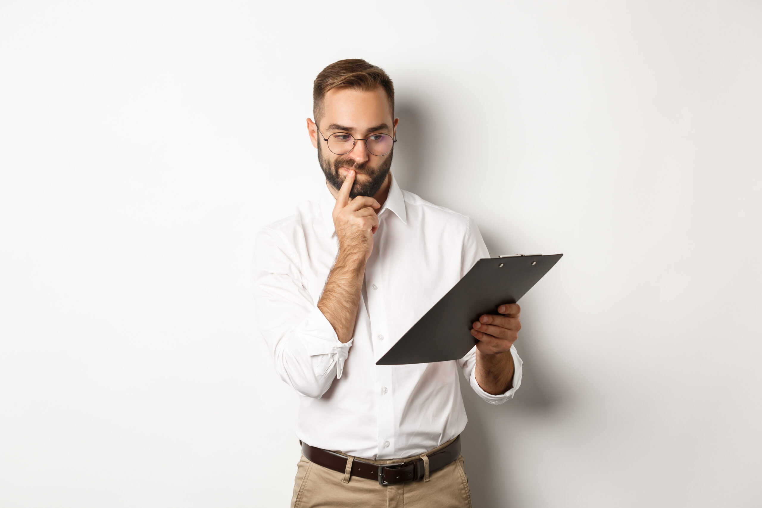 thoughtful-employee-looking-clipboard-having-doubts-standing-white-background-scaled