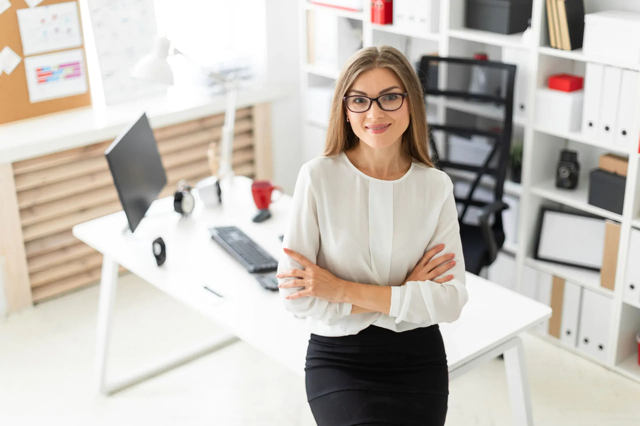 a-young-girl-is-standing-leaning-on-a-table-in-the-office-scaled