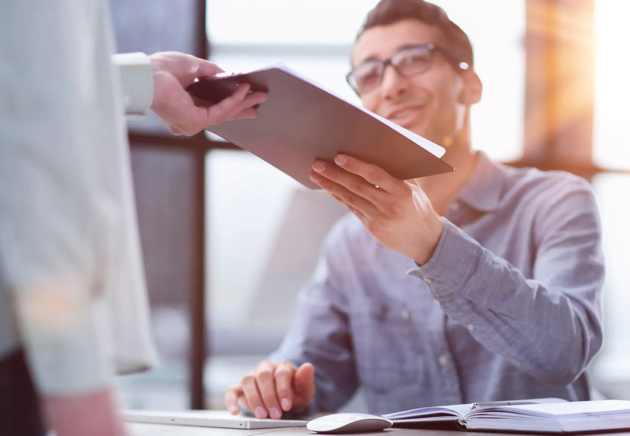 close-up-businessman-taking-folders-from-hand-scaled