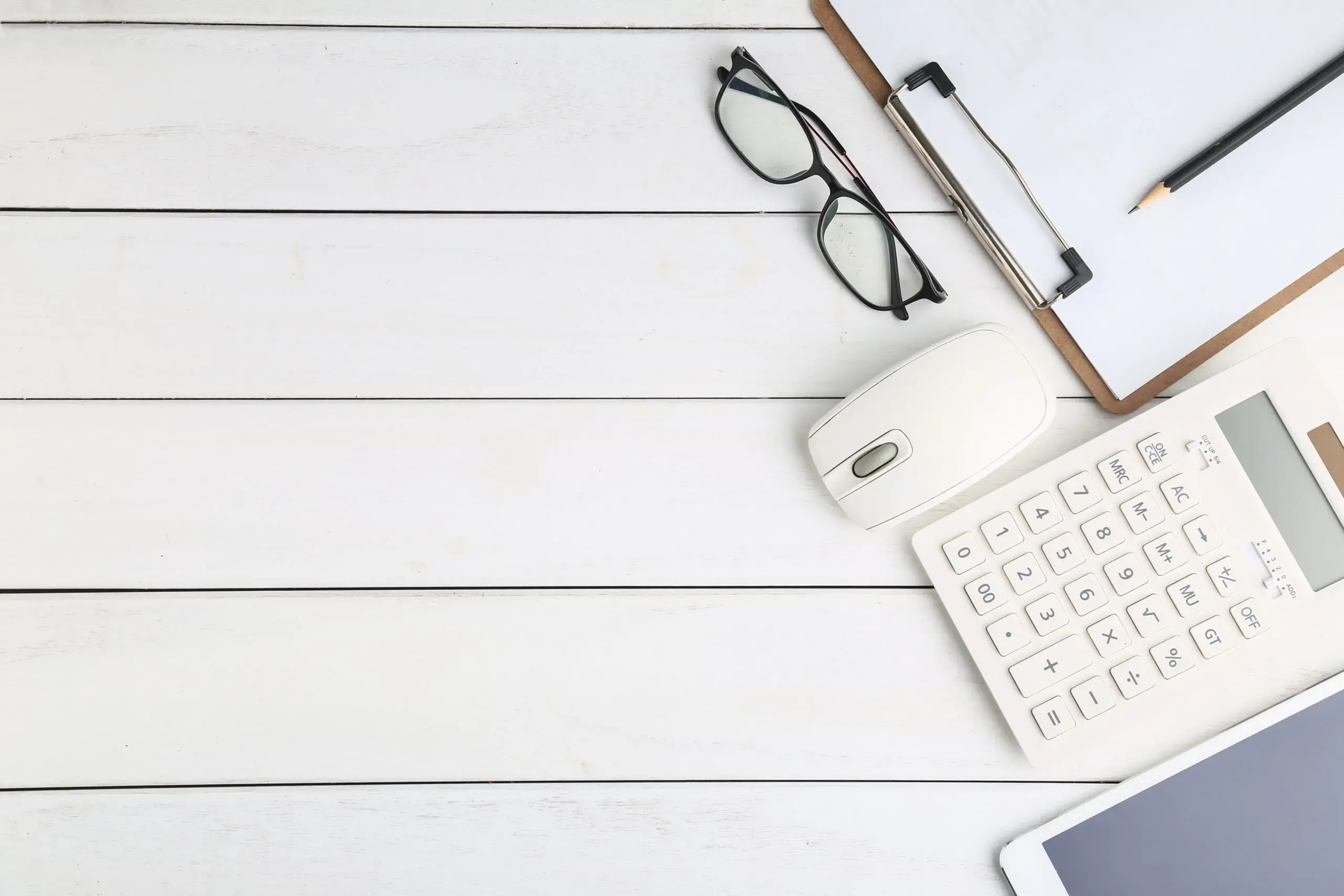 glasses-calculator-and-tablet-on-white-neat-desk-scaled